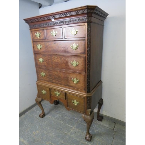 703 - A George III mahogany chest on stand, the Greek key cornice above a foliate carved frieze and quarte... 