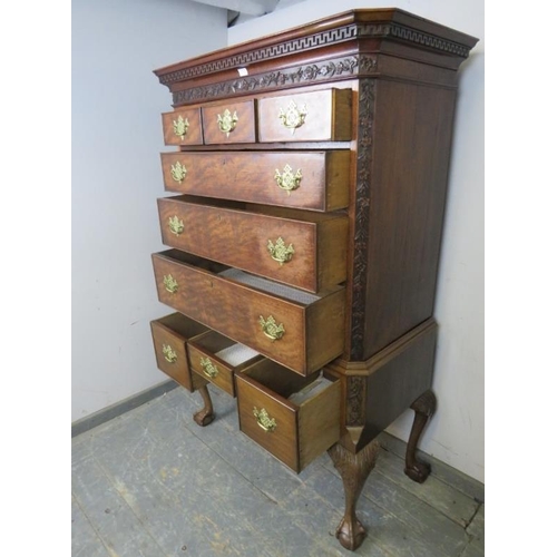 703 - A George III mahogany chest on stand, the Greek key cornice above a foliate carved frieze and quarte... 