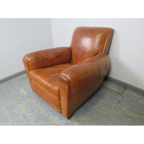 707 - A vintage low and deep club armchair, upholstered in tan leather with brass studs, on block feet. 
H... 