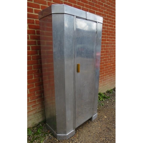 711 - An Art Deco Period aluminium double wardrobe with chamfered corners, the single door with butterscot... 