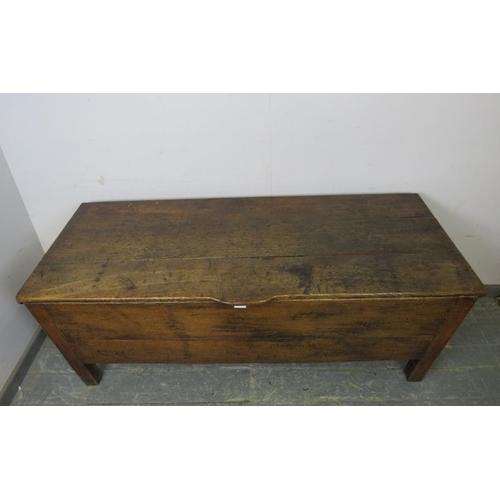 712 - An 18th century French oak dough bin of exceptionally large proportions, the hinged lid with shaped ... 