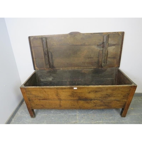 712 - An 18th century French oak dough bin of exceptionally large proportions, the hinged lid with shaped ... 