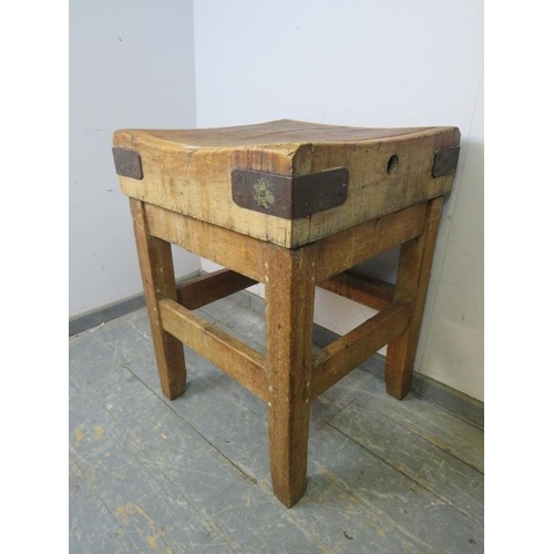 713 - An antique beech butcher’s block with cast iron bound corners, on an antique pine stand with stretch... 