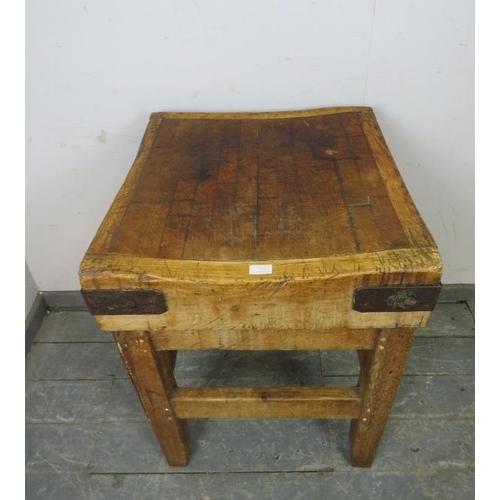 713 - An antique beech butcher’s block with cast iron bound corners, on an antique pine stand with stretch... 