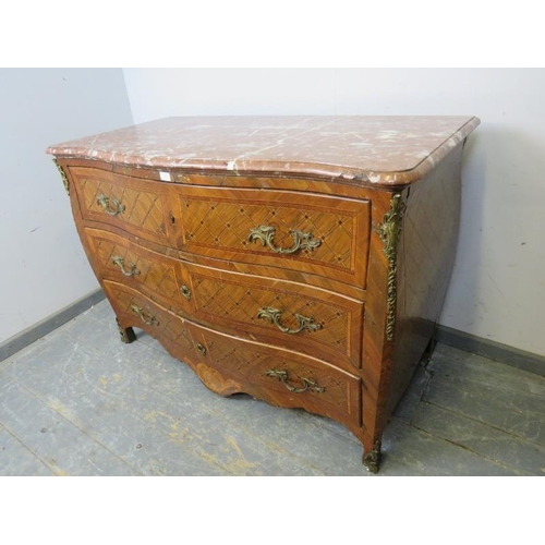 716 - A late 18th/early 19th century Louis XV style walnut serpentine commode chest, having a rouge marble... 