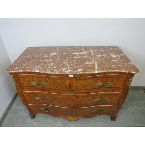 716 - A late 18th/early 19th century Louis XV style walnut serpentine commode chest, having a rouge marble... 