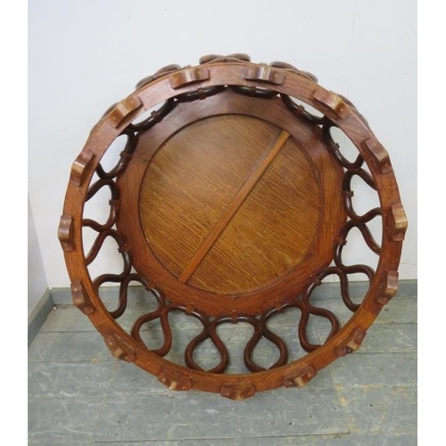 722 - A vintage low Chinese hardwood barrel coffee table, the circular top on an intricately carved base s... 