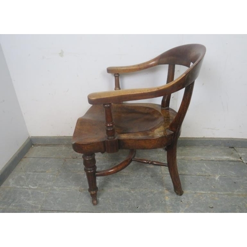 730 - A 19th Century walnut captain's chair, the shaped back above a deeply sculpted seat, on turned suppo... 