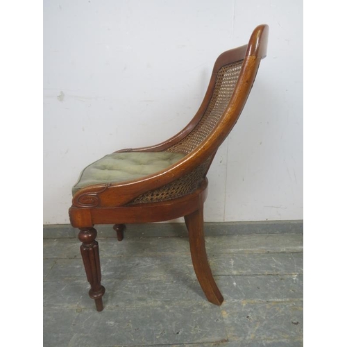 736 - A Victorian mahogany bergere library chair, the raked back with curved sides, on fluted front suppor... 