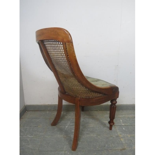 736 - A Victorian mahogany bergere library chair, the raked back with curved sides, on fluted front suppor... 