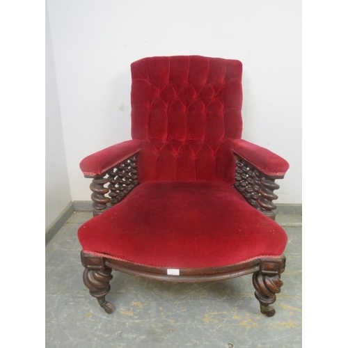 740 - A Victorian mahogany library chair, upholstered in a crimson velvet buttoned material and having bar... 