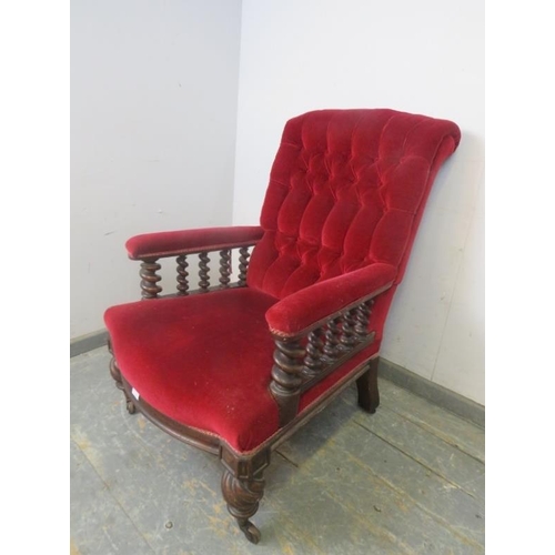 740 - A Victorian mahogany library chair, upholstered in a crimson velvet buttoned material and having bar... 