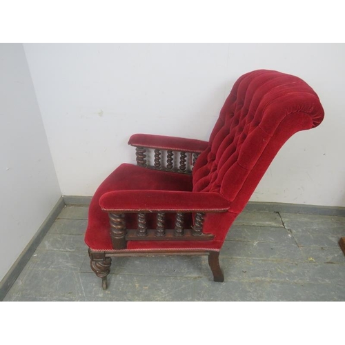 740 - A Victorian mahogany library chair, upholstered in a crimson velvet buttoned material and having bar... 