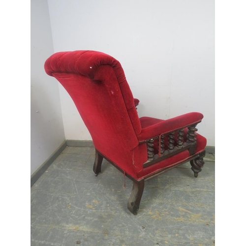 740 - A Victorian mahogany library chair, upholstered in a crimson velvet buttoned material and having bar... 