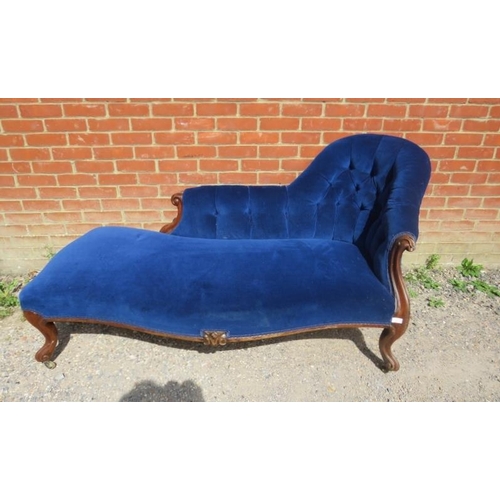 741 - A Victorian mahogany chaise longue, upholstered in buttoned royal blue velvet material, on ogee supp... 