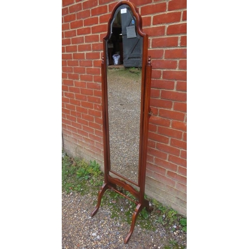 745 - A vintage bevelled cheval mirror within a shaped walnut surround, the stand with turned finials and ... 