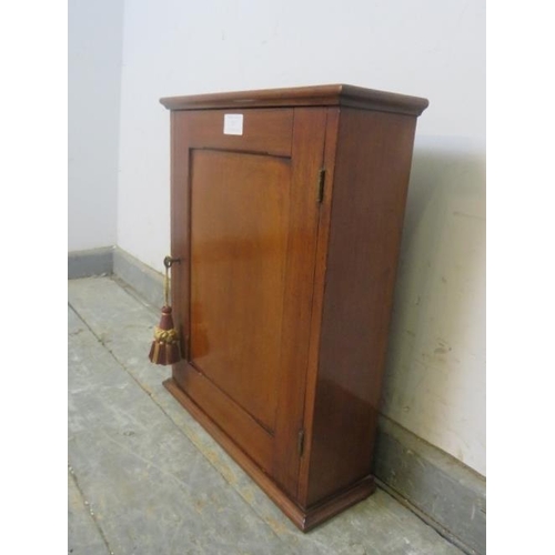 757 - A late Victorian mahogany wall-hanging key cupboard, the panelled door opening onto a fitted shelf a... 