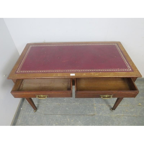 762 - An Edwardian mahogany writing table by Maple & Co, the top with inset red leather surface, housing t... 