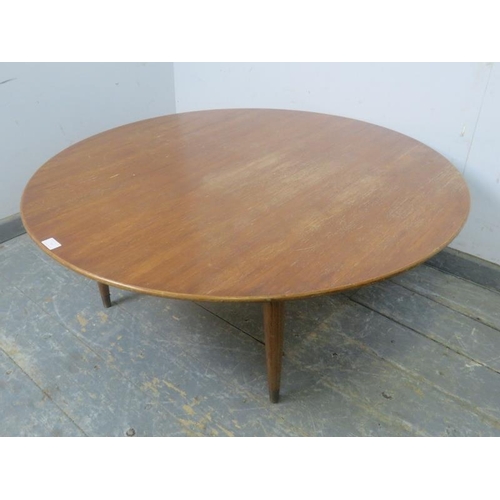 765 - A mid-century Scandinavian circular teak coffee table by Folke Olsson, on turned supports with brass... 