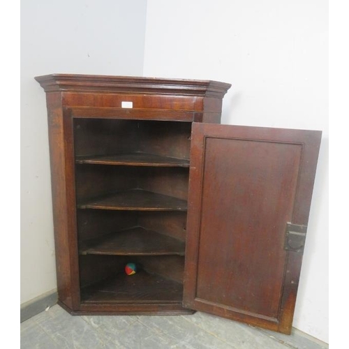 767 - A George III mahogany and oak hanging corner cupboard, inlaid and crossbanded, with marquetry spandr... 