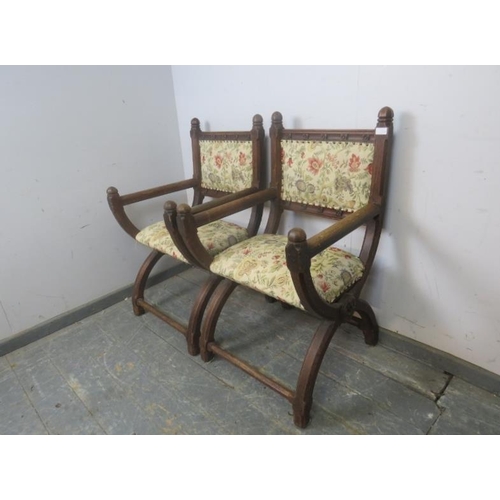 768 - A pair of 19th Century oak Glastonbury chairs, the curved and chamfered uprights with dome finials a... 