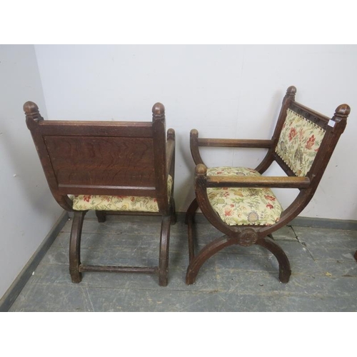 768 - A pair of 19th Century oak Glastonbury chairs, the curved and chamfered uprights with dome finials a... 