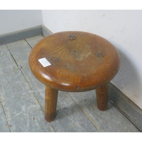 771 - An antique elm milking stool, the dished top on turned supports.
H30cm Diameter 29cm (approx).
Condi... 