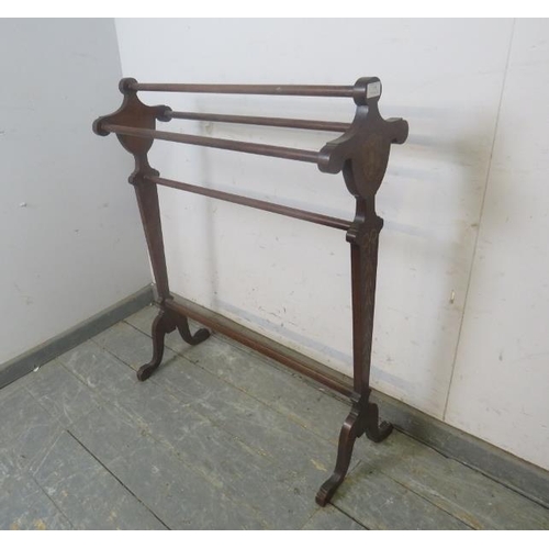 772 - An Edwardian mahogany triple towel rail, the shaped end supports with Classical marquetry inlay, on ... 