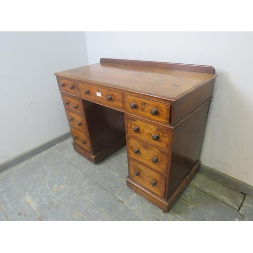 774 - A 19th century mahogany pedestal desk, housing a configuration of nine graduated drawers with turned... 