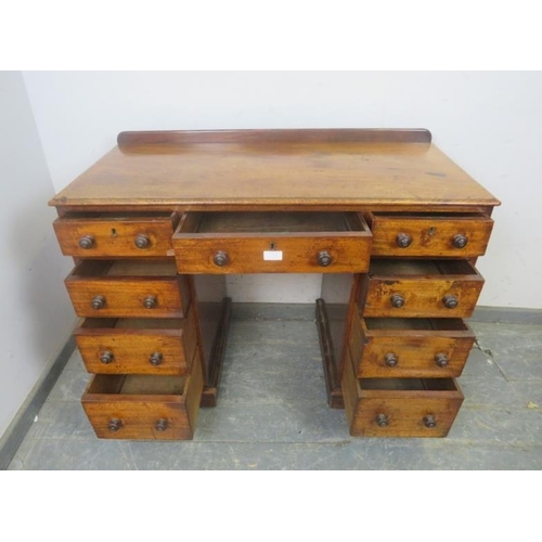 774 - A 19th century mahogany pedestal desk, housing a configuration of nine graduated drawers with turned... 