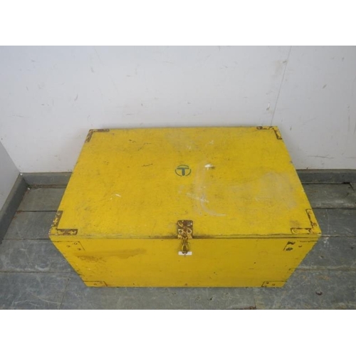 776 - A vintage Telecom flat top trunk painted yellow, having internal candle box, hasp & staple catch and... 