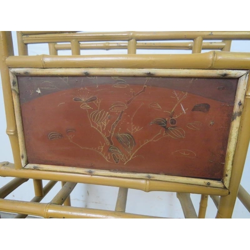 782 - A turn of the century bamboo magazine rack, having hand-painted Chinoiserie panels to both sides and... 