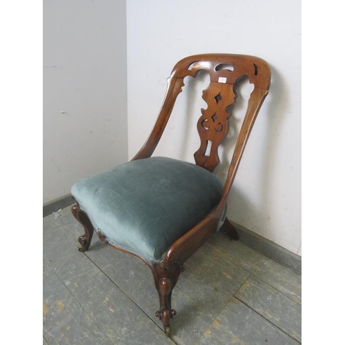 786 - A Victorian rosewood occasional chair, the raked back with curved sides and pierced splat, the sprun... 