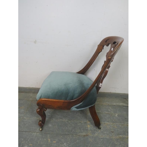 786 - A Victorian rosewood occasional chair, the raked back with curved sides and pierced splat, the sprun... 