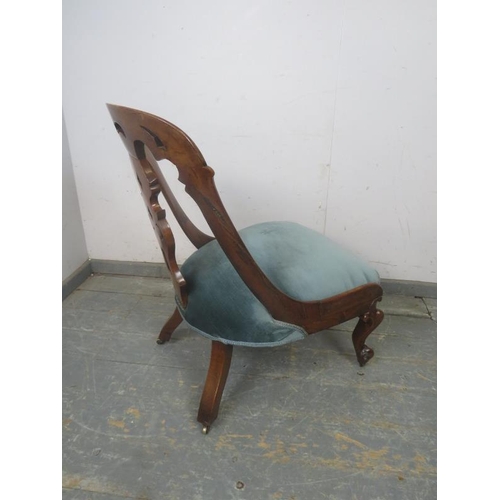 786 - A Victorian rosewood occasional chair, the raked back with curved sides and pierced splat, the sprun... 