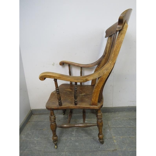 791 - A 19th century elm and beech Windsor chair of large proportions, the carved and pierced backsplat wi... 