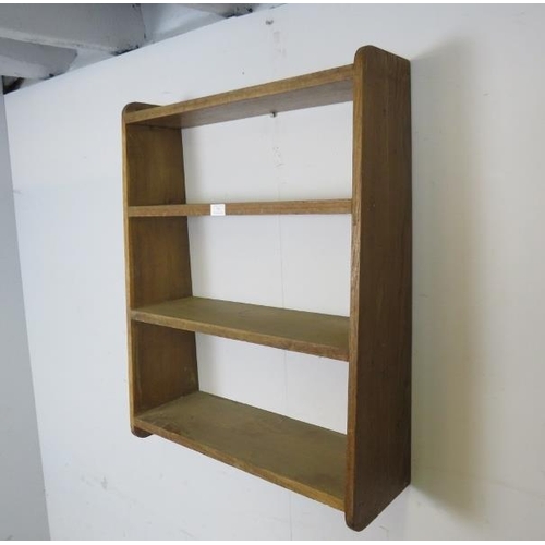 795 - A vintage light oak wall hanging shelf, of four graduated open shelves, with curved side supports. H... 