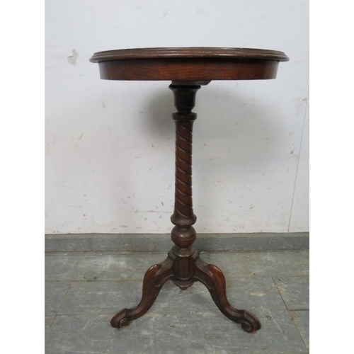 796 - A Victorian walnut wine table, the top with profuse parquetry inlay, on a spiral carved column with ... 