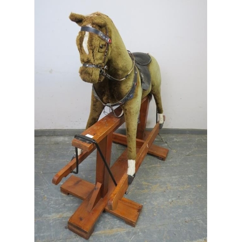 797 - A vintage 48” rocking horse by Pegasus toys, covered in brown fur and with real leather saddle and g... 