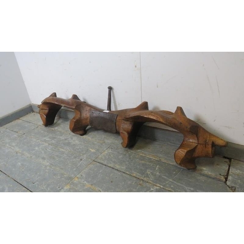 799 - A 19th century or earlier rustic French fruitwood double ox yoke, with   cast iron mounts. H32cm W12... 