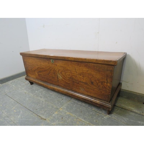 803 - A 19th century elm flat topped trunk of good colour, on stile supports. 
H43cm W106cm D36cm (approx)... 