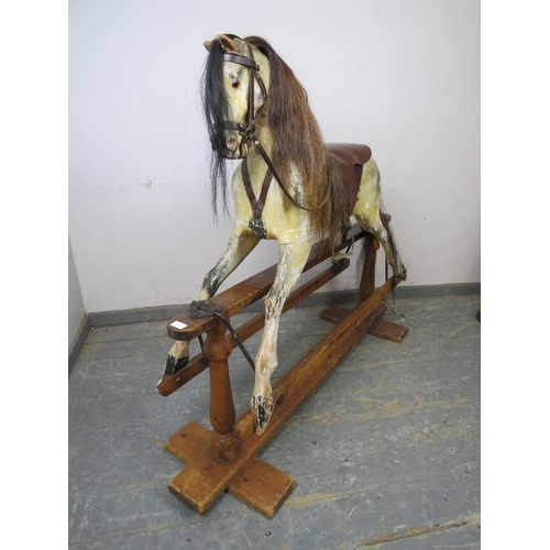 804 - A Victorian carved 48” rocking horse, retaining the original paintwork and with real horsehair mane ... 