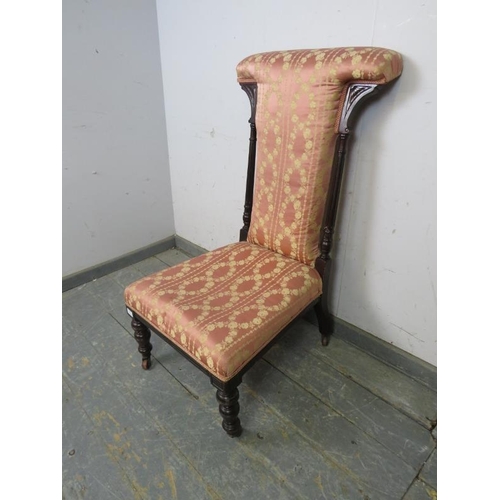 807 - A late Victorian ebonised prix dieux, having reeded uprights and upholstered in pink damask material... 