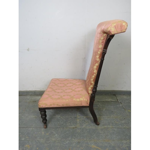 807 - A late Victorian ebonised prix dieux, having reeded uprights and upholstered in pink damask material... 