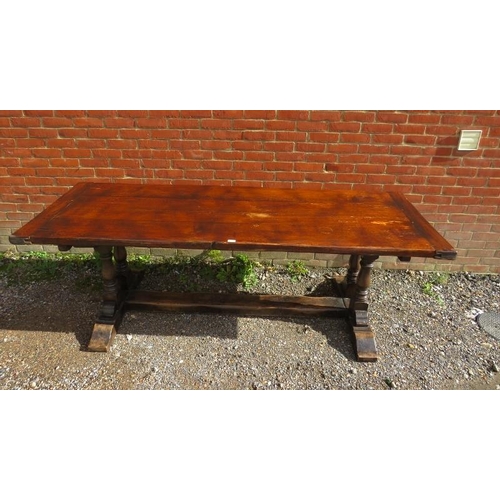 816 - A vintage medium oak refectory table, on twin baluster end supports and rail feet with a middle stre... 