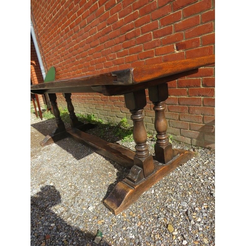 816 - A vintage medium oak refectory table, on twin baluster end supports and rail feet with a middle stre... 