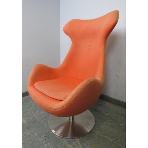 817 - A contemporary swivel and reclining ‘egg’ lounge chair by Steijer, covered in salmon pink fabric, on... 