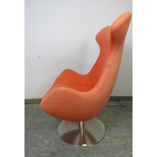 817 - A contemporary swivel and reclining ‘egg’ lounge chair by Steijer, covered in salmon pink fabric, on... 