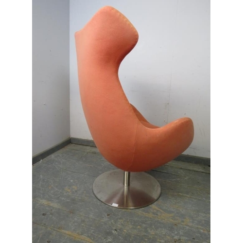 817 - A contemporary swivel and reclining ‘egg’ lounge chair by Steijer, covered in salmon pink fabric, on... 