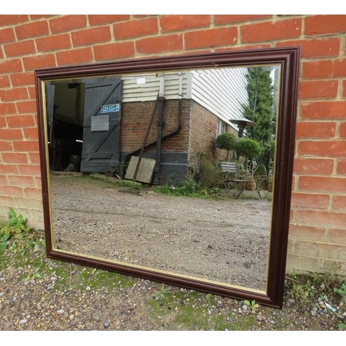 824 - A large rectangular bevelled wall mirror within a parcel gilt and moulded wooden surround. 
H104cm W... 